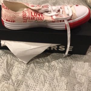 Red and white low top Converse shoes